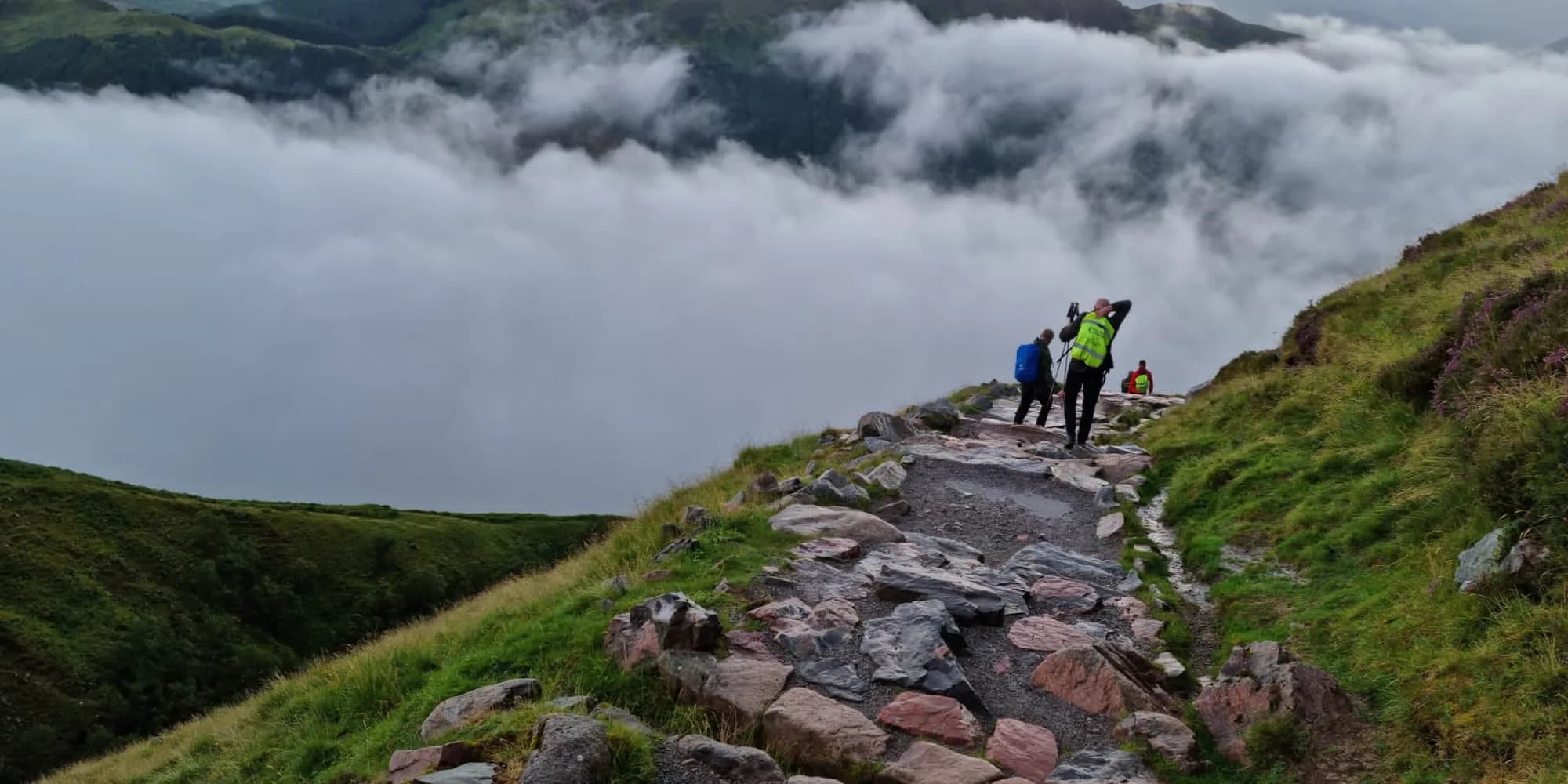 A Challenge Central hiking group crossing a mountain landscape